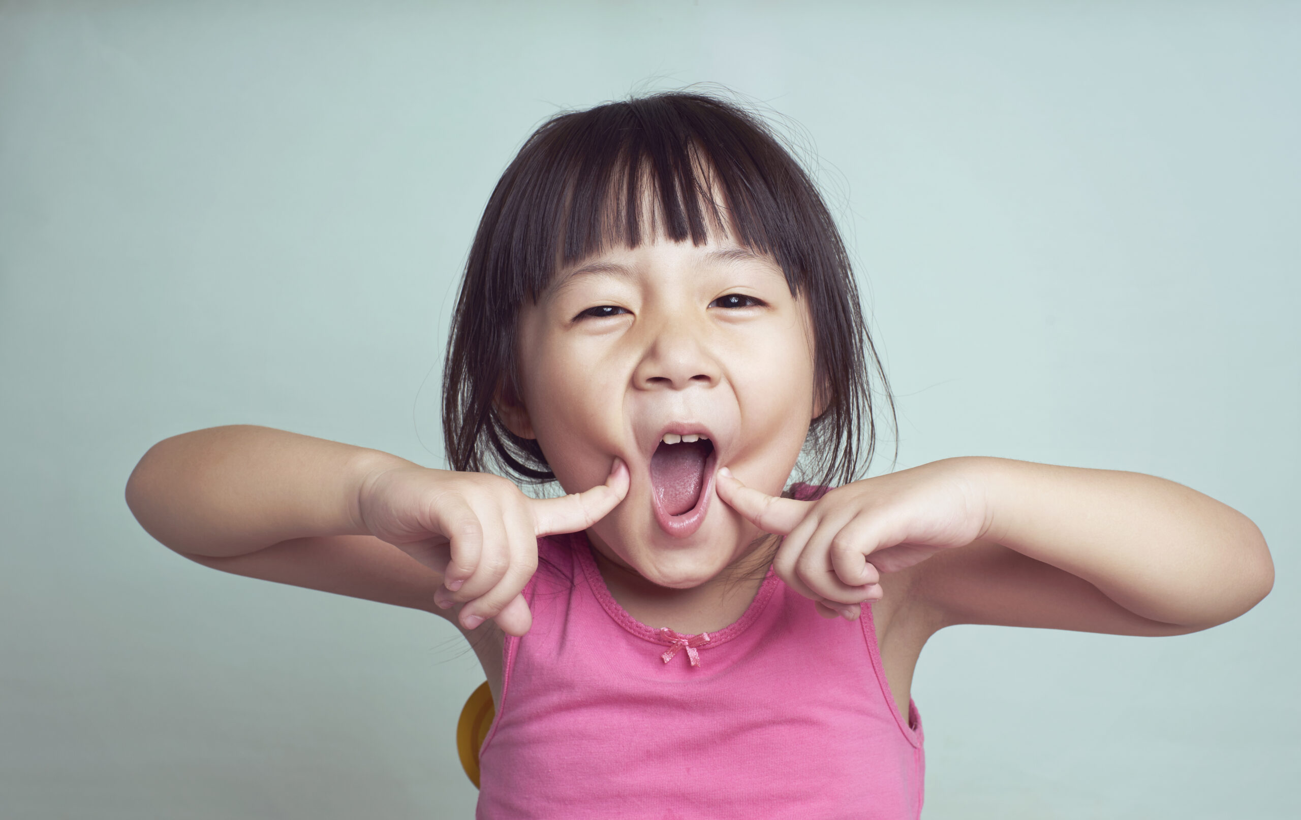 Playful portrait of young girl smiling