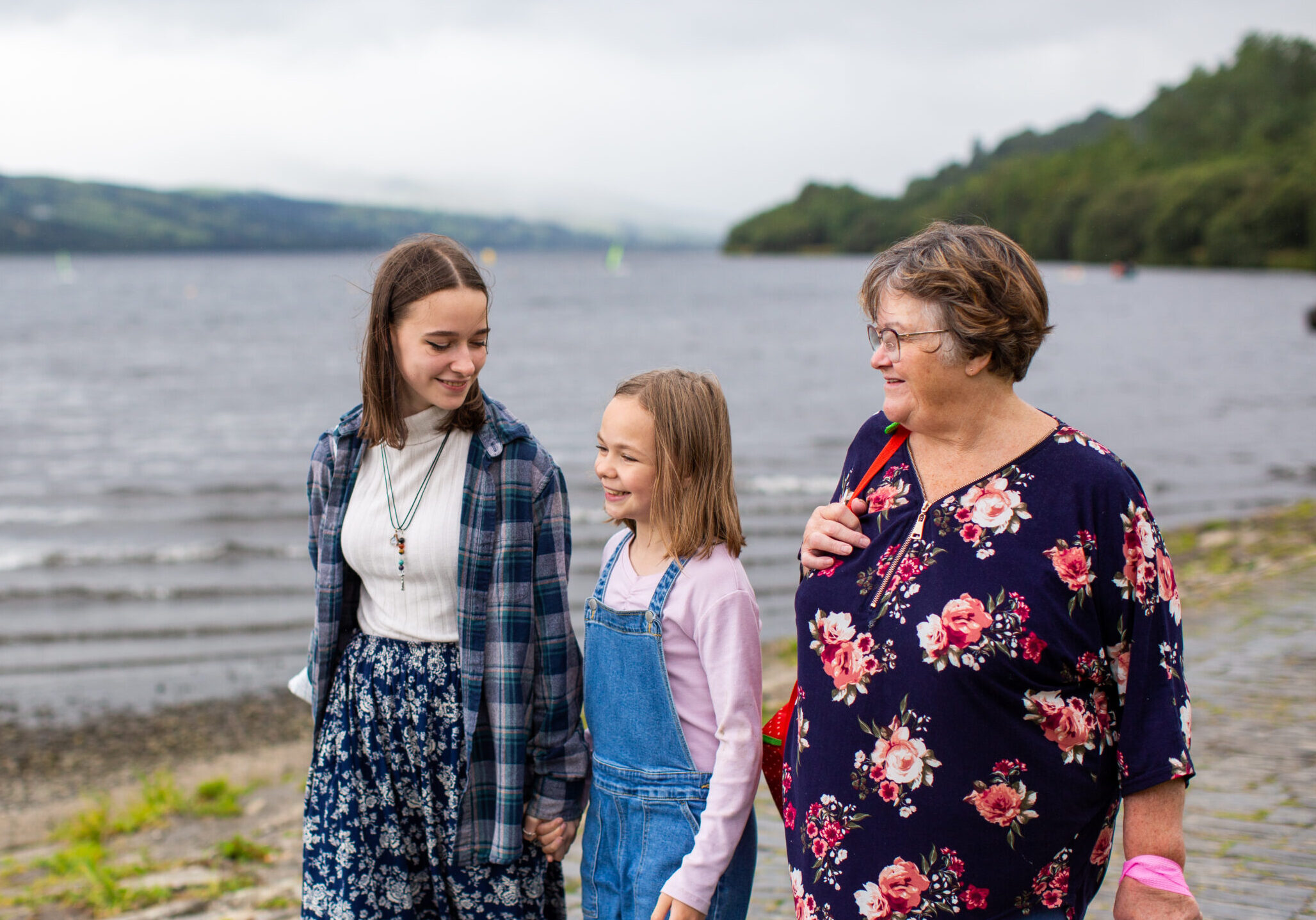 Foster carer, young person and young girl going for a walk