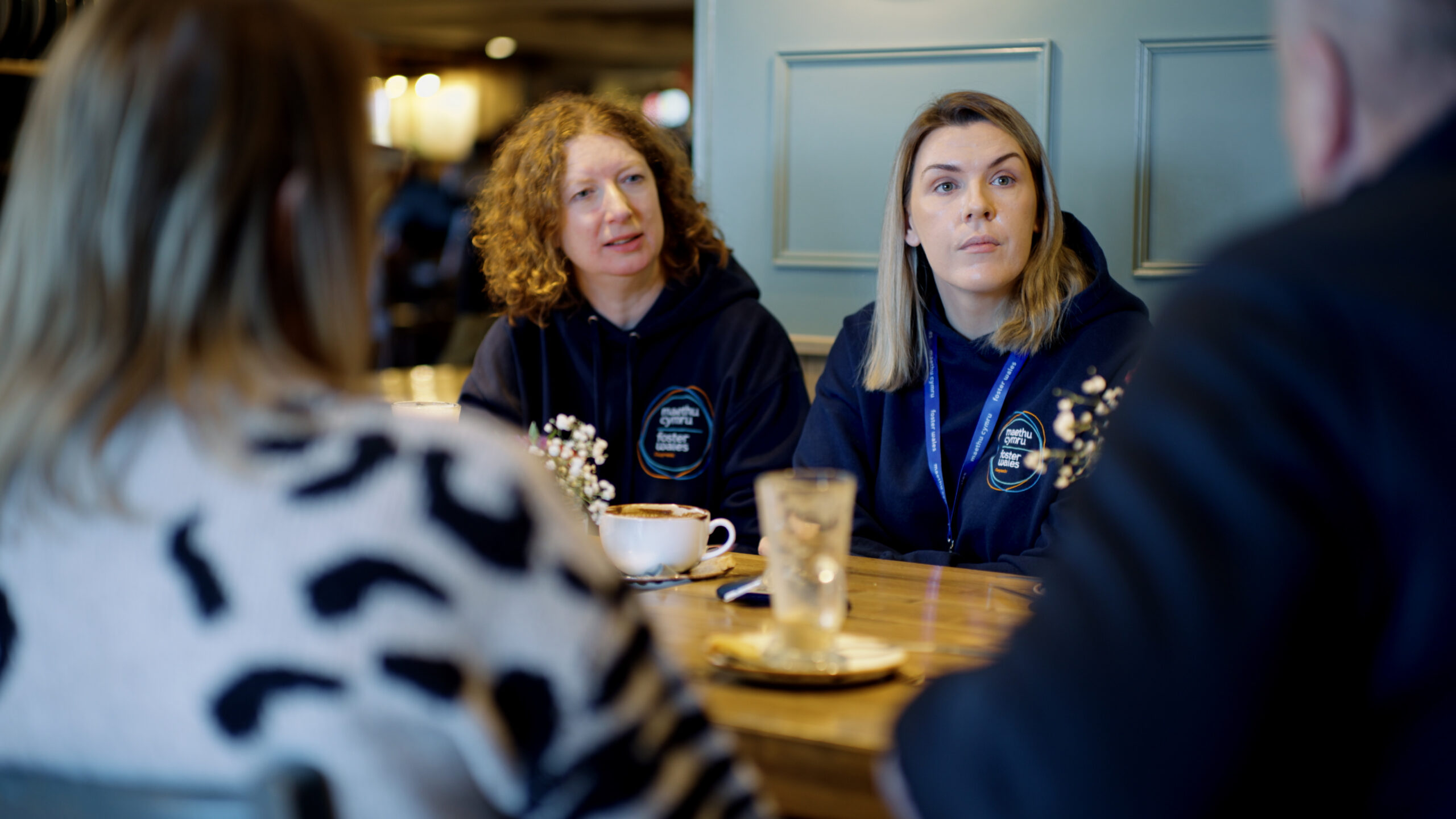 Two female social workers listening around a table