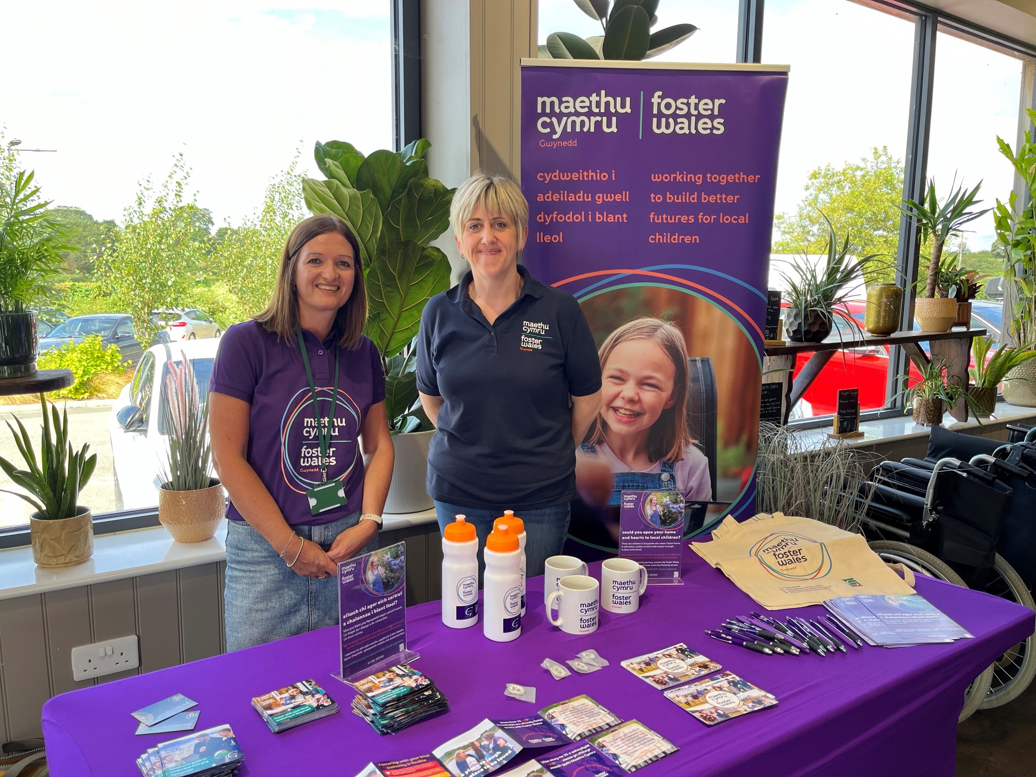 Two Maethu Cymru Gwynedd staff on an information stand